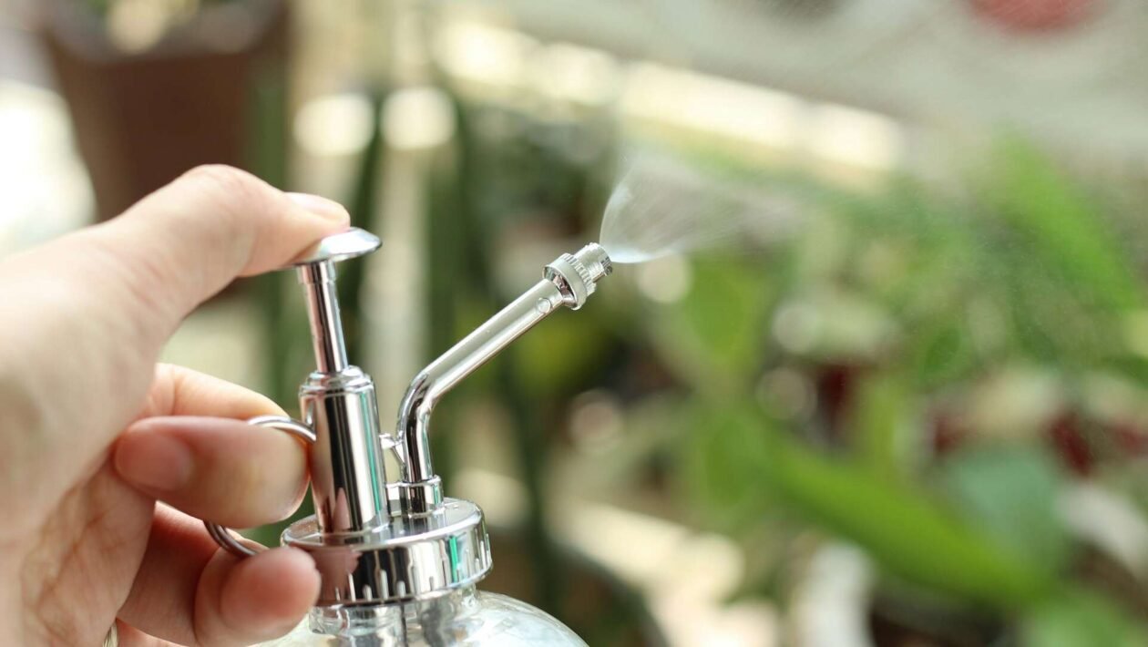 Ruke koje pomoću ključa zatežu slavinu kako bi zaustavile curenje vode, prikaz detalja popravka.