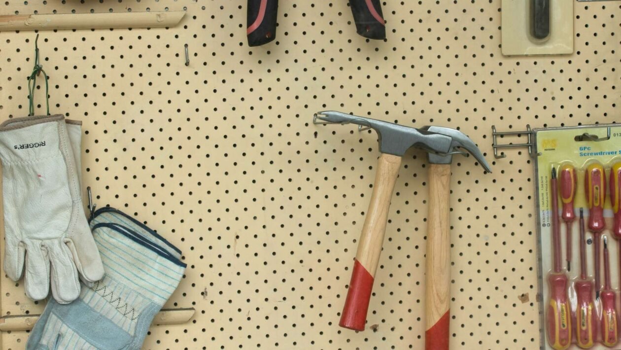 Bliski prikaz alata za uklanjanje fuga, uključujući nož za fuge i brusni papir, spremnih za rad.