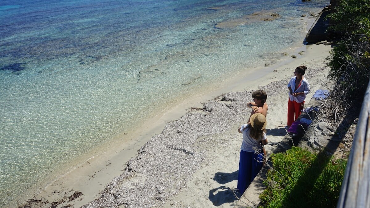 Ljudi u šetnji uz more na Dugom otoku tijekom večeri.