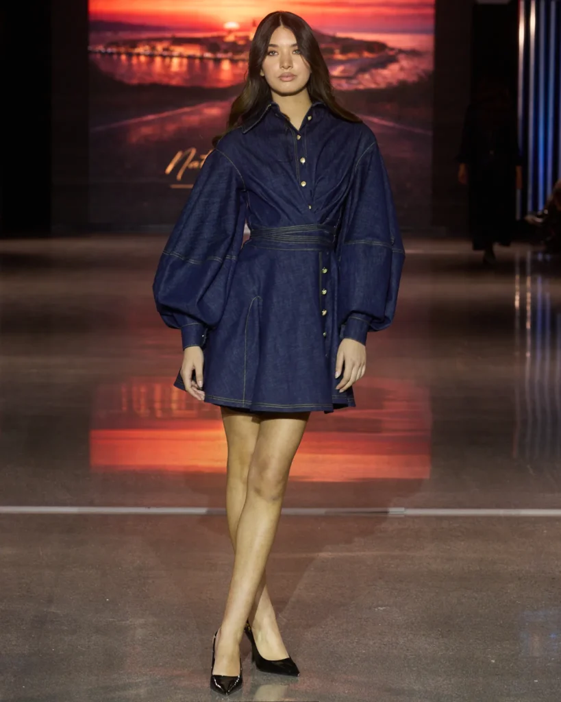 Natalija Smogor denim mini haljina s naglašenim voluminoznim rukavima i zlatnim detaljima.