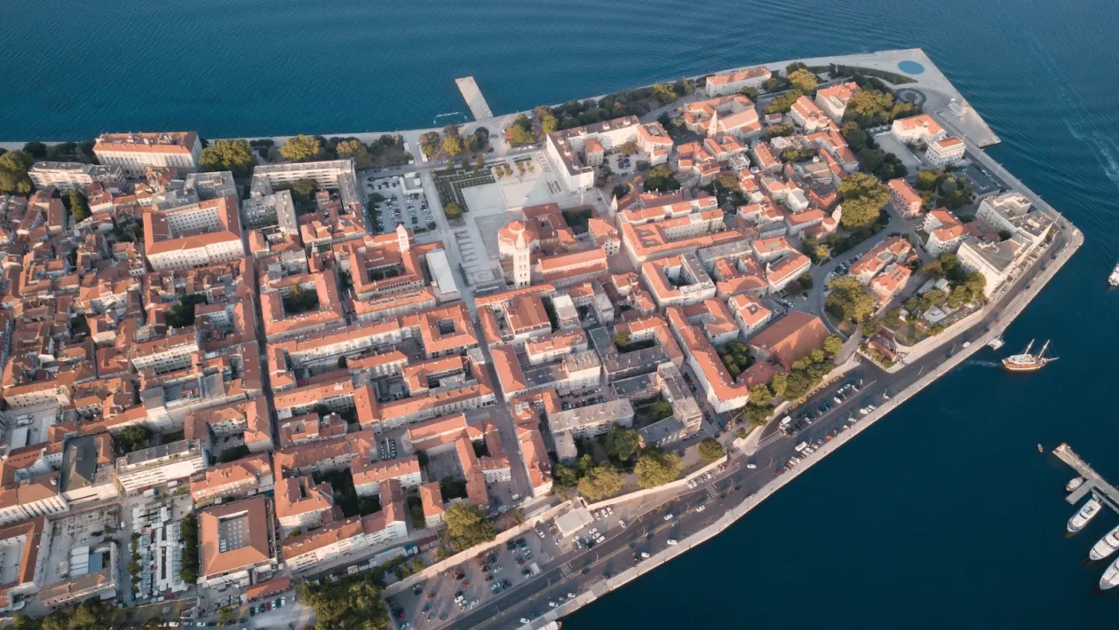 Zadar old town aerial Adriatic view captured on a clear day, showing the historic peninsula surrounded by the calm Adriatic Sea.