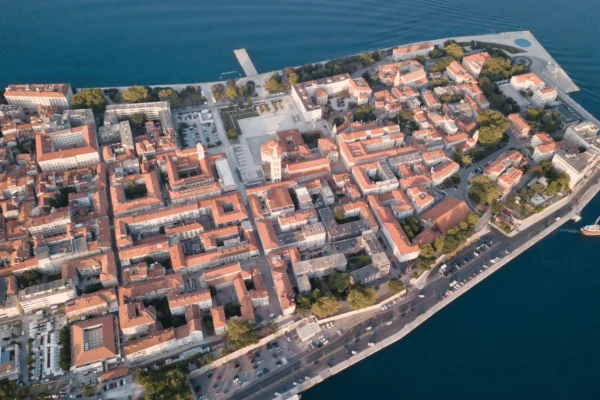 Zadar old town aerial Adriatic view captured on a clear day, showing the historic peninsula surrounded by the calm Adriatic Sea.