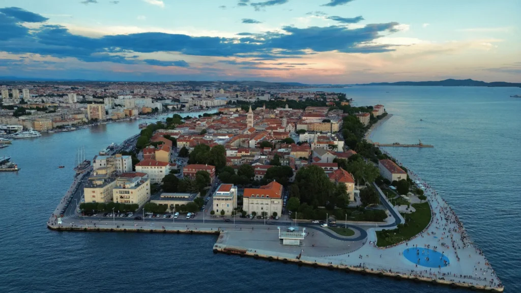 Aerial photo of Zadar old town on the Adriatic coast, highlighting city walls, harbor area and dense historic streets.